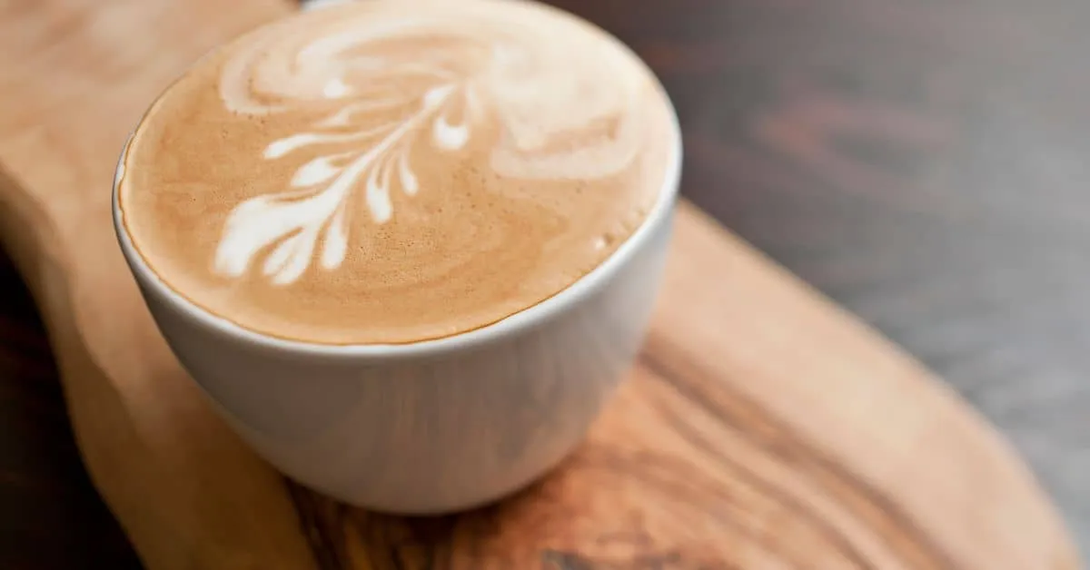 Flat White coffee on a wooden table.