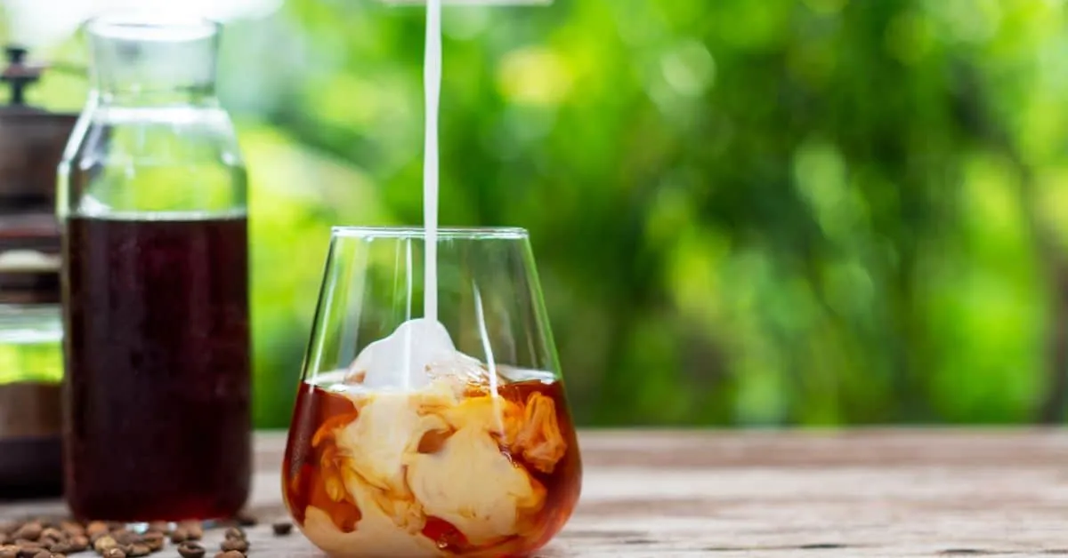 Glass of decaf cold brew coffee with milk