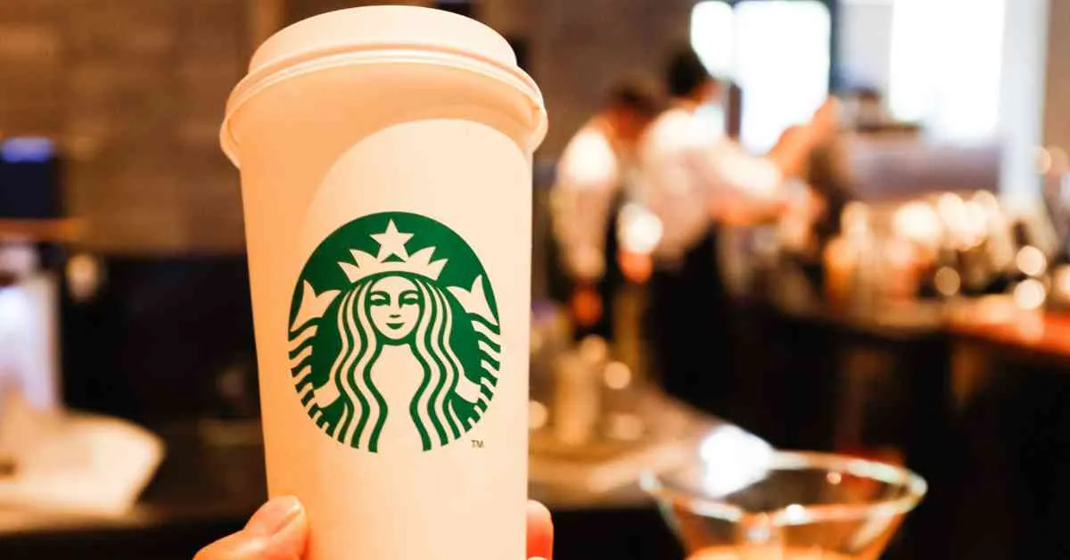 Holding a cup of Starbucks coffee
