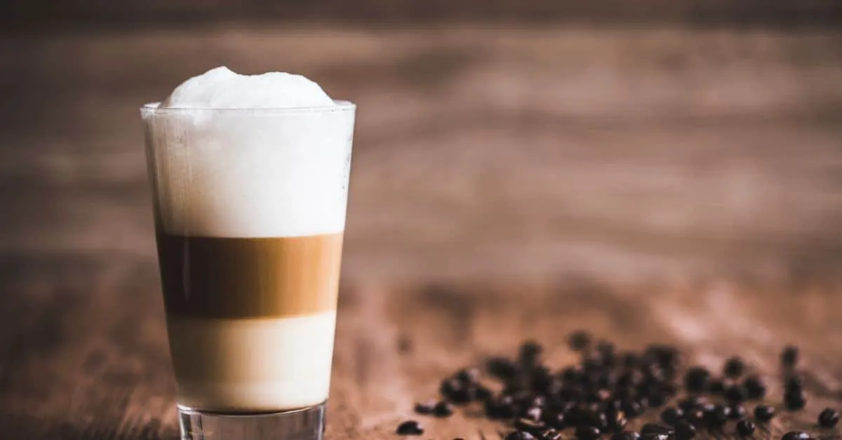 Layered latte coffee on a wooden table