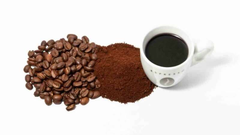 Coffee Beans and Espresso Powder next to a cup