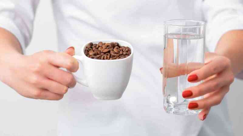 Cup of Coffee Beans and a Glass Of Water