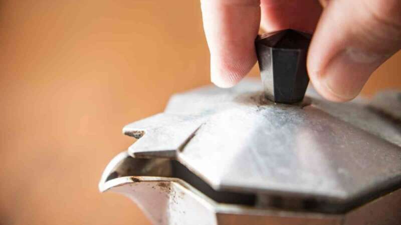 Opening the lid of a Moka Pot