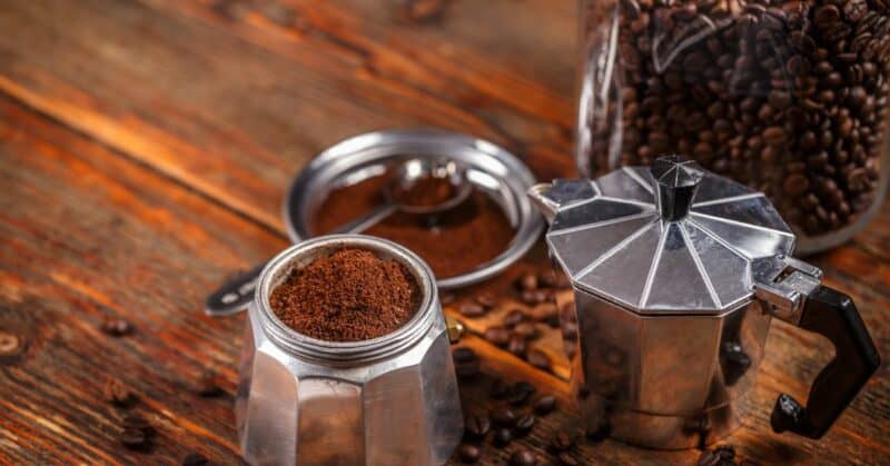 Ground coffee and a Moka pot