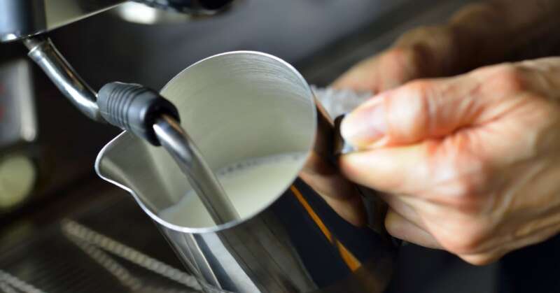 Barista steaming milk.