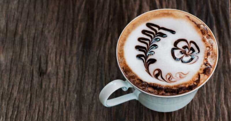 A delicious cup of mocha coffee on a wooden table.