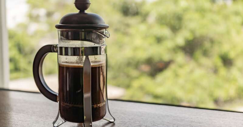 Glass French Press on a table.