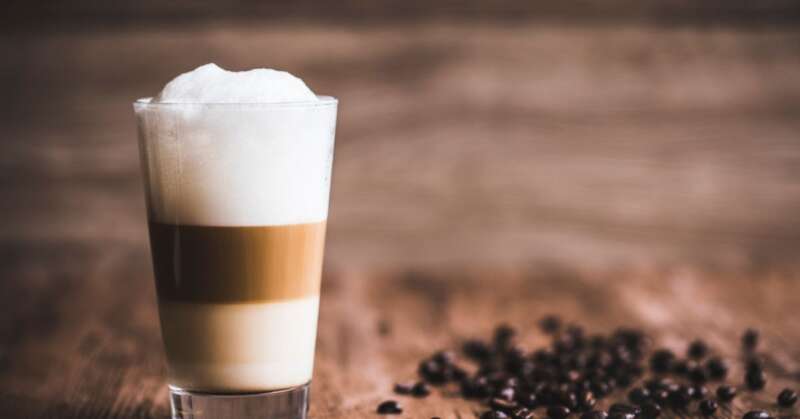 Layered latte coffee on a wooden table