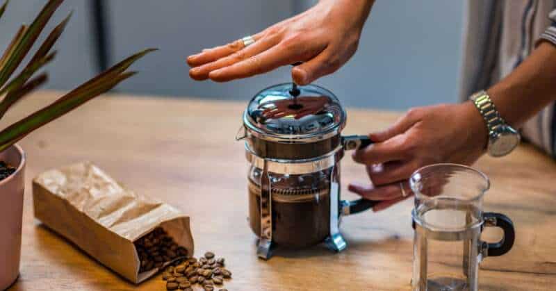 Pressing down the plunger of a French Press